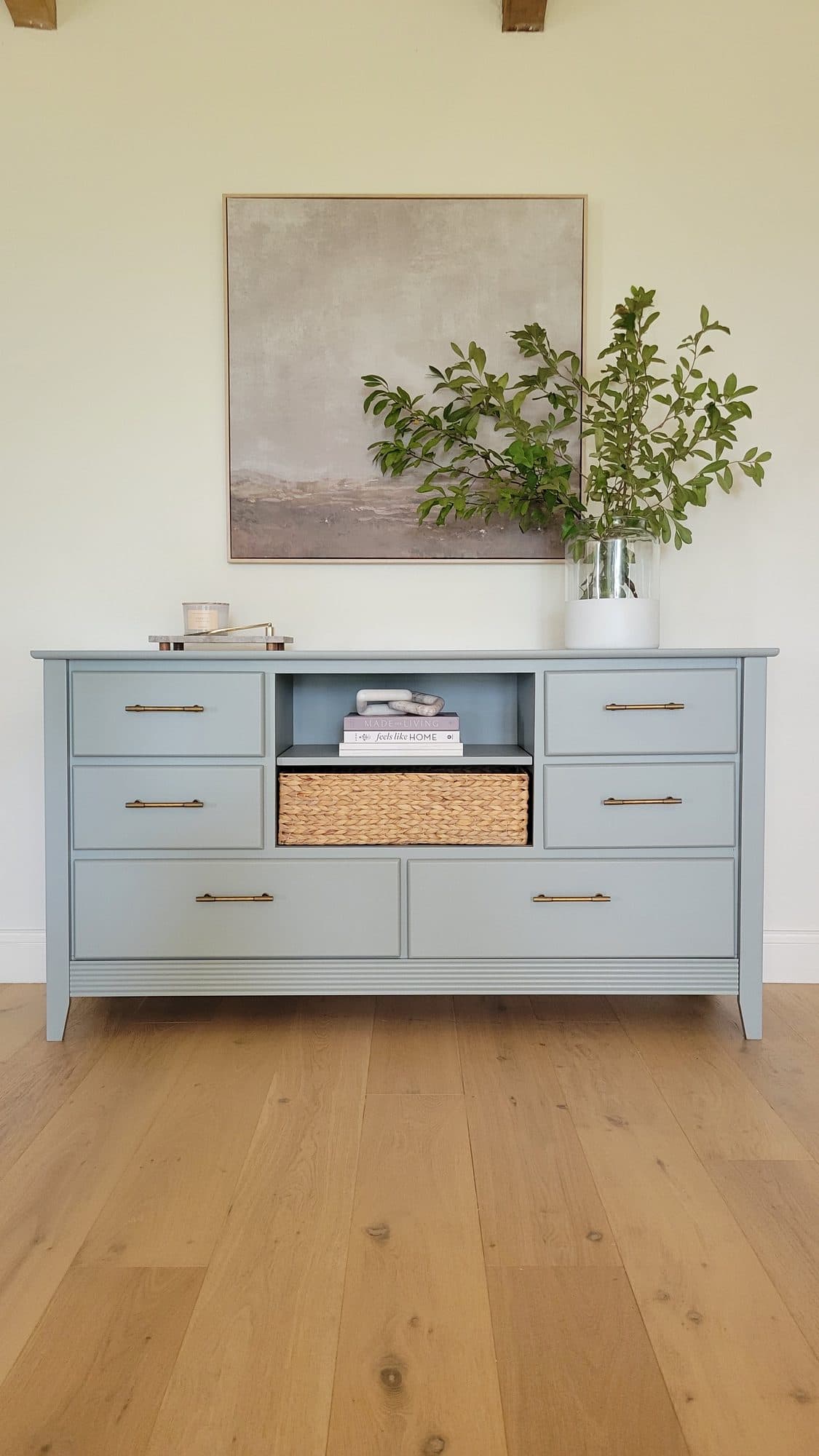 Dresser refinished in soft blue-gray with brass pulls and a woven basket