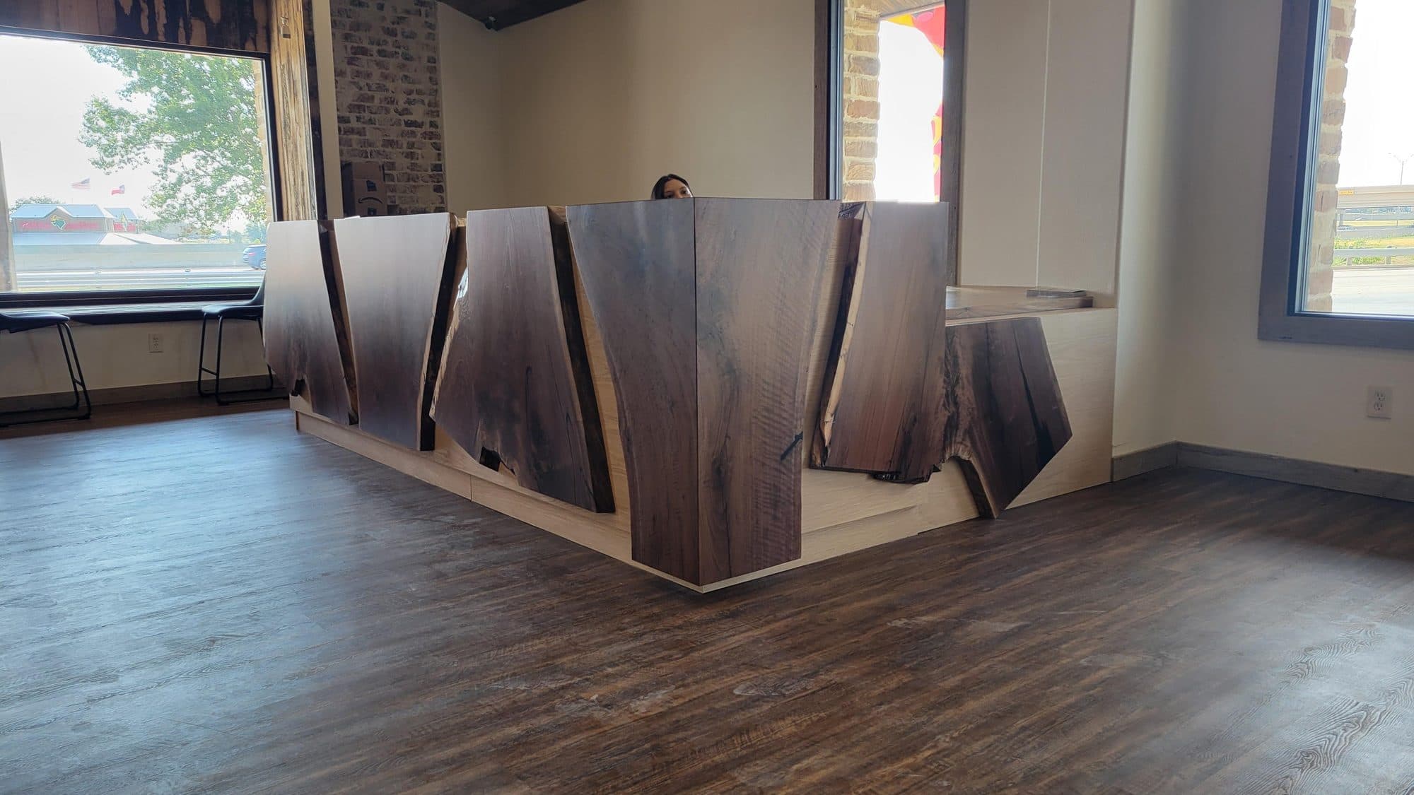 Reception desk faced with live-edge walnut slabs