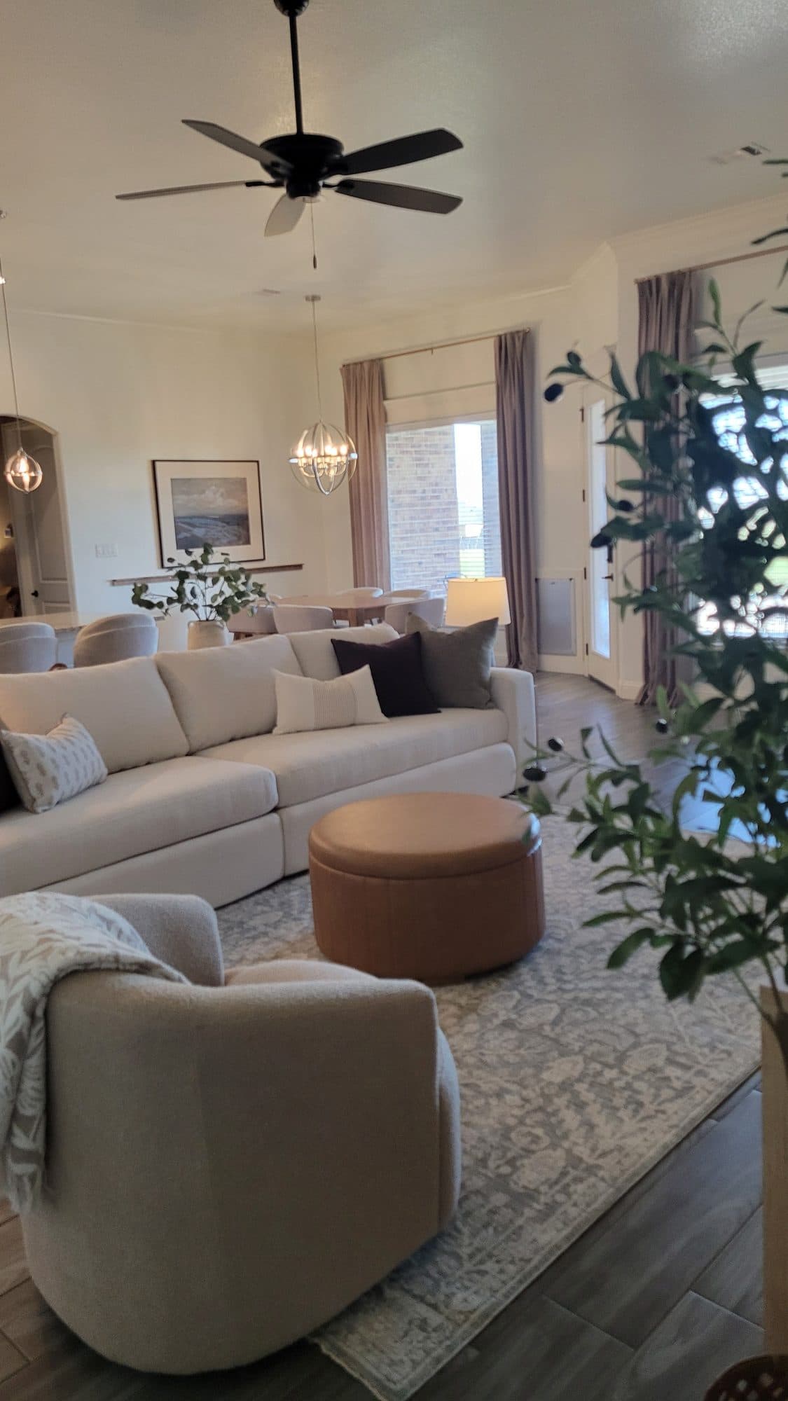 Living room with sectional, leather ottoman, and swivel chair